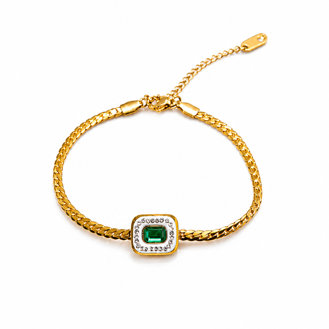 A gold chain bracelet featuring a square bezel-set green emerald-cut center stone surrounded by small clear stones, displayed on a clean white background.