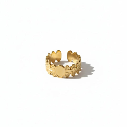 Gold ring with decorative design on a white background