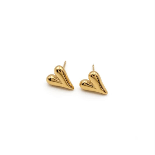 gold colored heart studs on white background