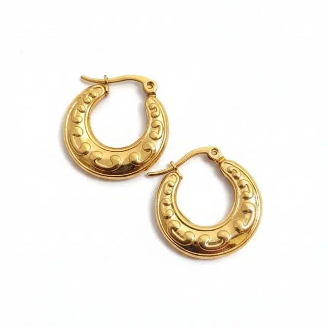 Gold hoop earrings on a white background