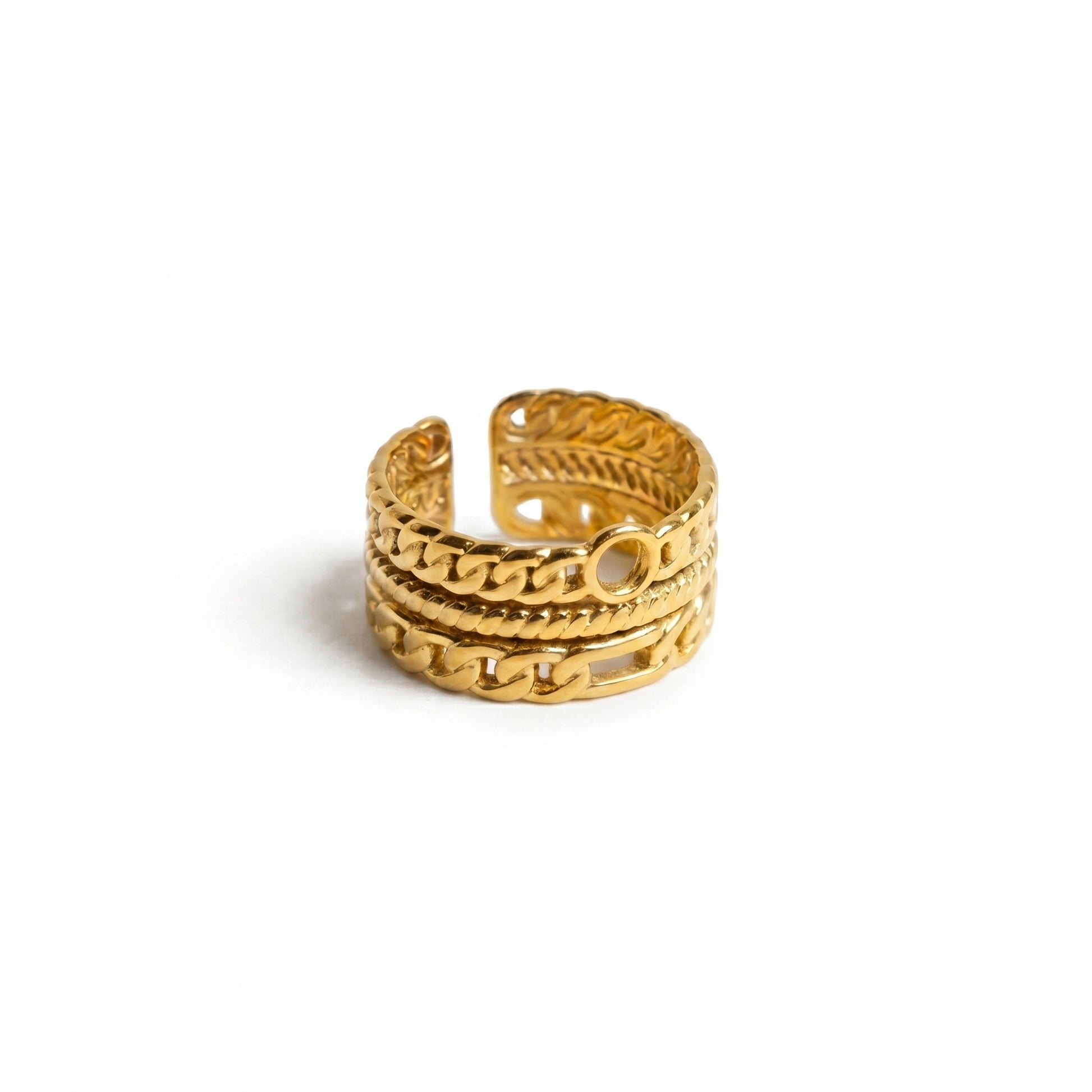 Gold ring with intricate design on a white background